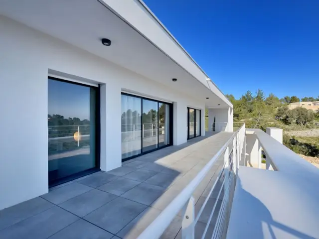 De larges baies vitrées pour bénéficier d'un panorama sur la vallée - Maison contemporaine garrigue nîmoise