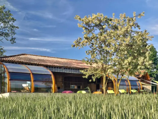 Une esthétique naturelle - Un abri de piscine sur un hangar rustique