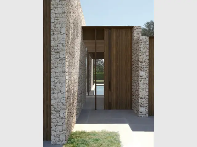 Des murs en pierre pour structurer le bâtiment - Une maison ton sur ton avec le paysage